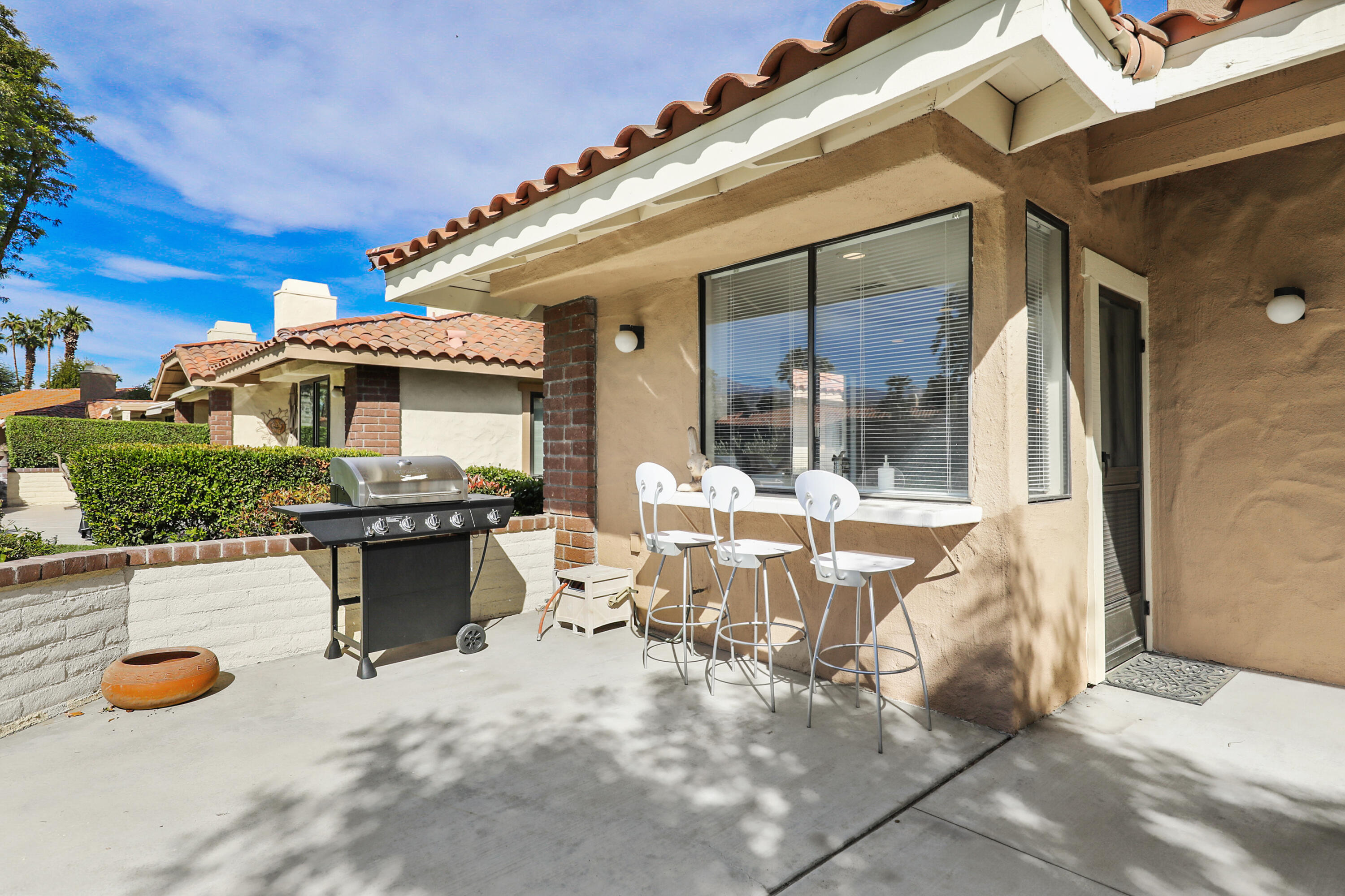 175 Gran Via Palm Desert, CA 92260 - Photo 28 of 36 a view of a patio with table and chairs and potted plants