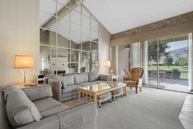 a living room with furniture and a lamp