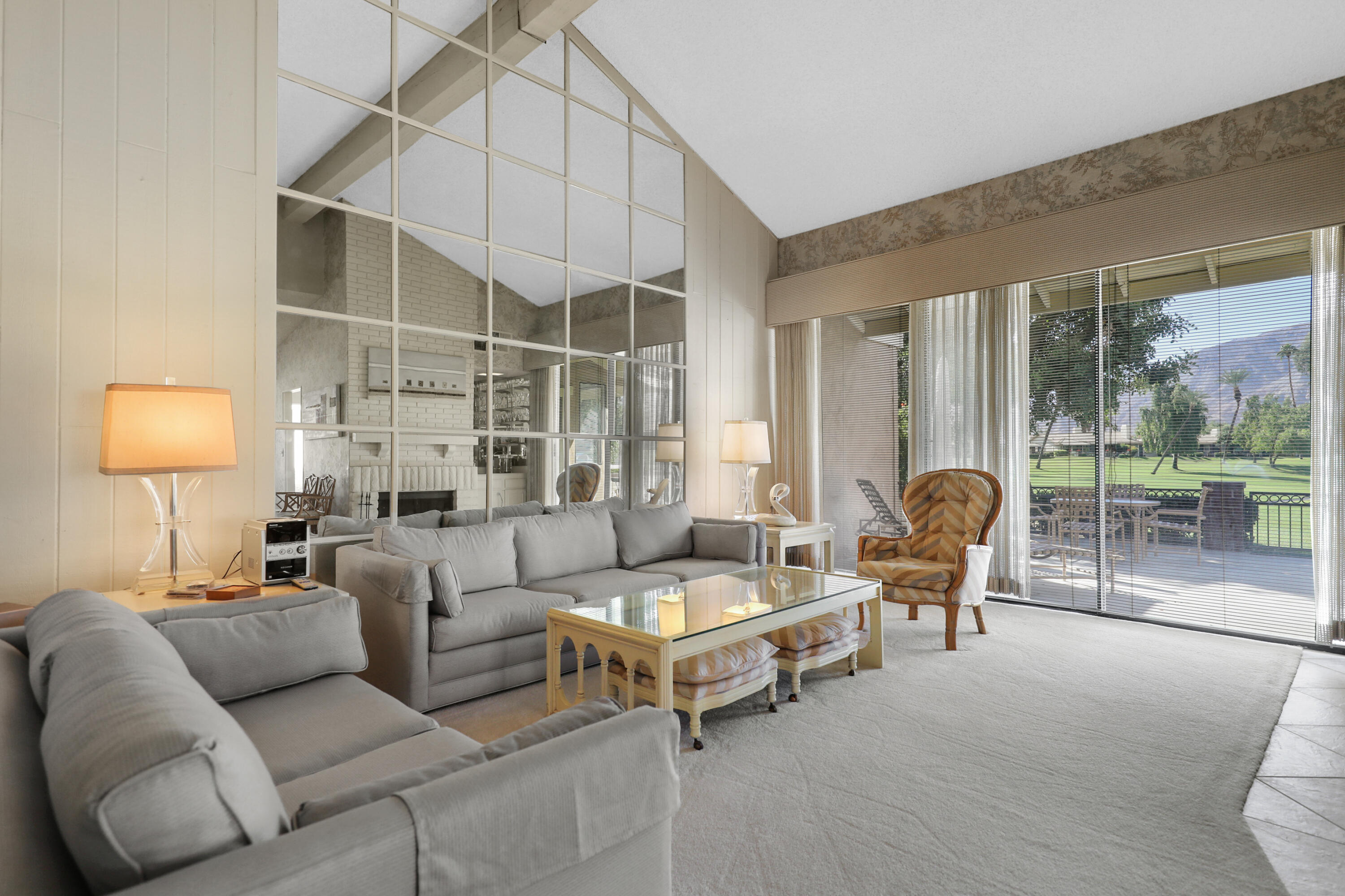 175 Gran Via Palm Desert, CA 92260 - Photo 5 of 36 a living room with furniture and a lamp