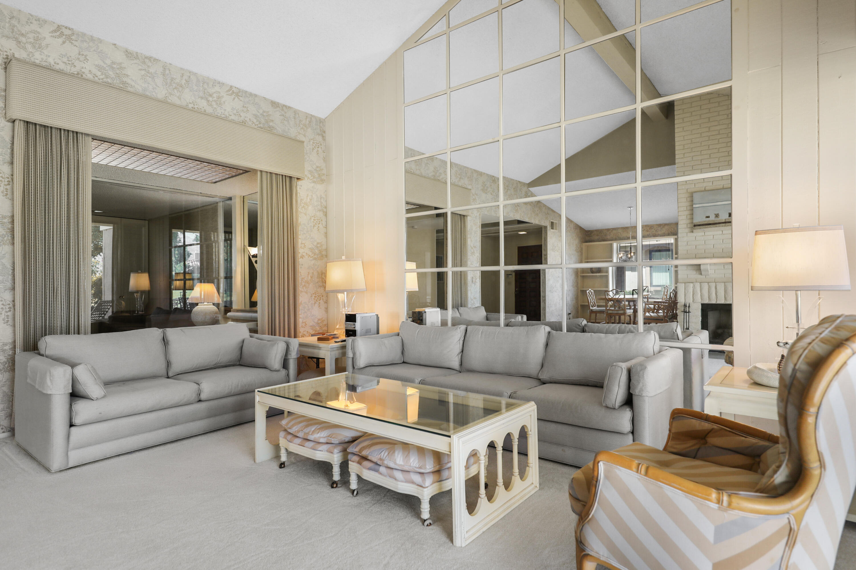 175 Gran Via Palm Desert, CA 92260 - Photo 6 of 36 a living room with furniture a rug and white walls