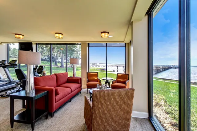 a living room with furniture tv and window