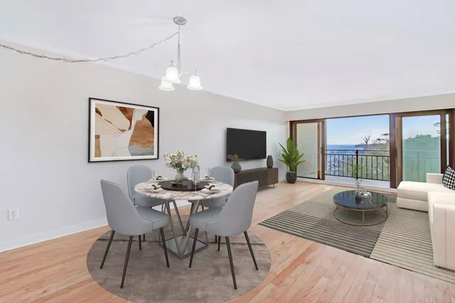 a view of a dining room with furniture large windows and wooden floor