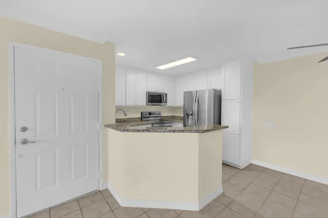 a kitchen with a sink stove and microwave