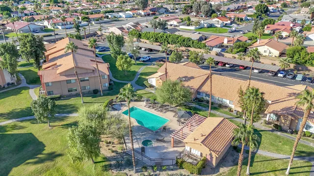 a view of kitchen with granite countertop cabinets and window