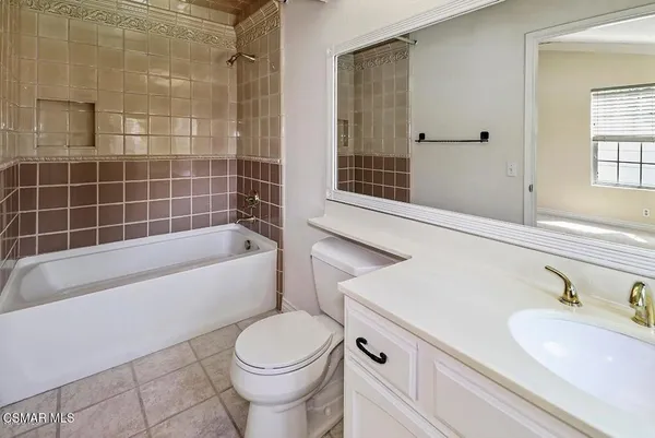 a bathroom with a sink a toilet and bathtub