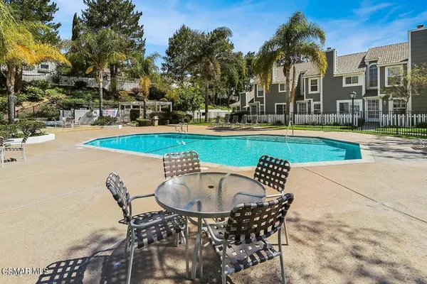 a roof deck with patio and outdoor seating