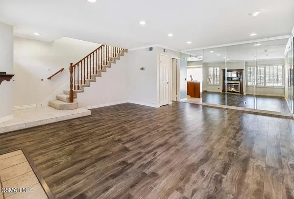 a view of an entryway with wooden floor