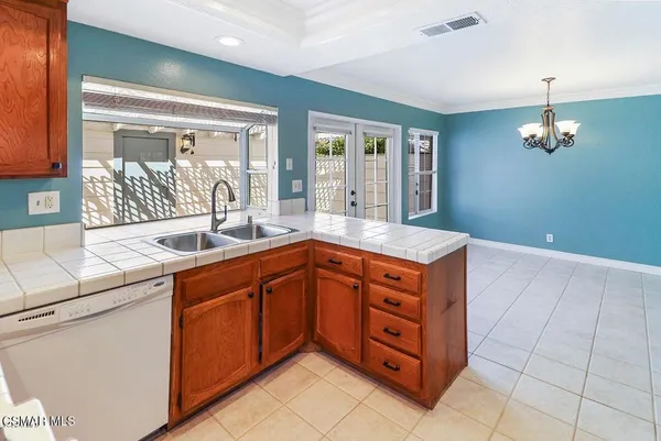 a kitchen with stainless steel appliances granite countertop a sink and cabinets