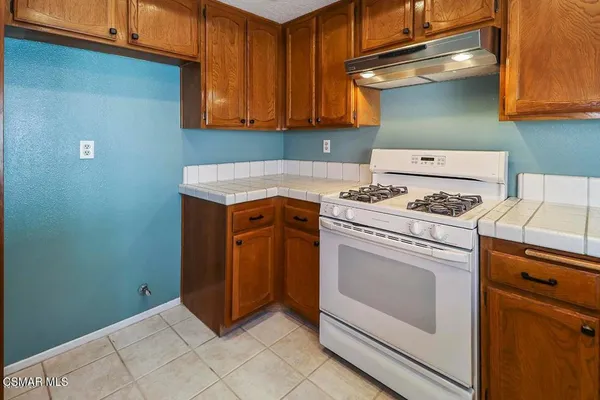 a kitchen with a stove and cabinets