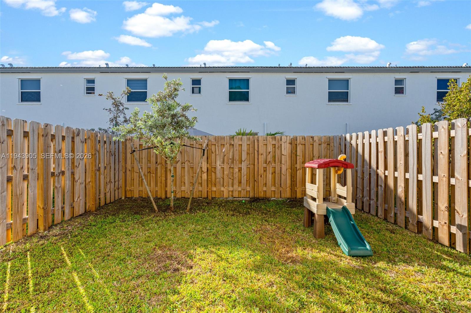 16276 Southwest 291st Street Homestead, FL 33033 - Photo 21 of 22 a backyard of a house with table and chairs