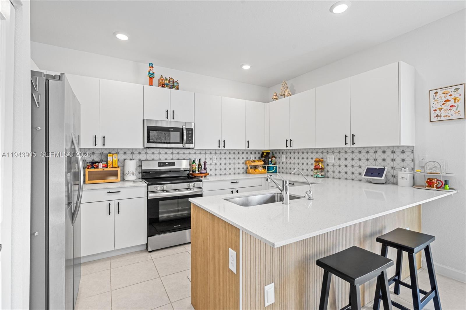 16276 Southwest 291st Street Homestead, FL 33033 - Photo 3 of 22 a kitchen with stainless steel appliances a stove a sink a microwave and a refrigerator