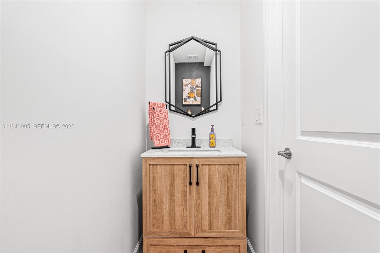 16276 Southwest 291st Street Homestead, FL 33033 - Photo 8 of 22 a bathroom with a sink and a mirror