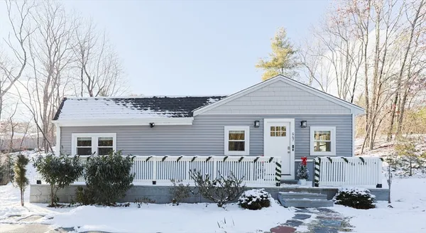 a view of a house with a yard covered in snow