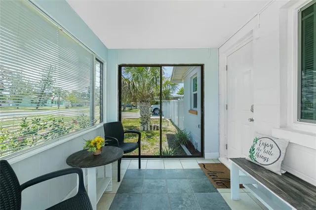 a living room with furniture a clock on wall and a table