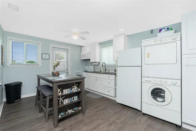 a kitchen with granite countertop a sink stove and cabinets