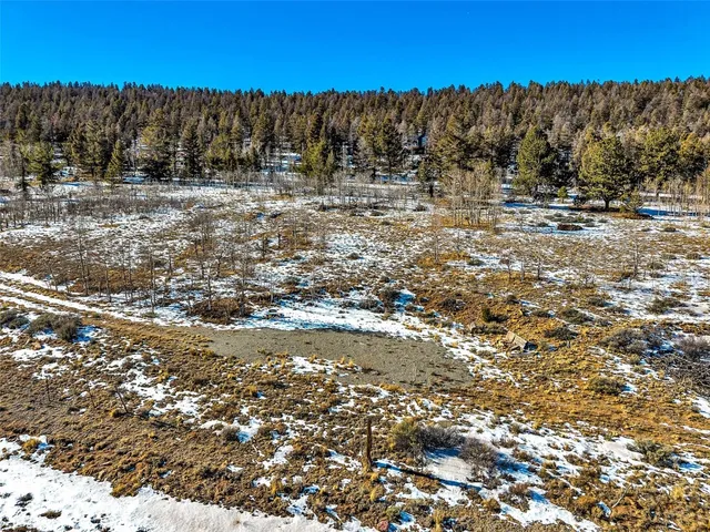 a view of a yard with wooden fence