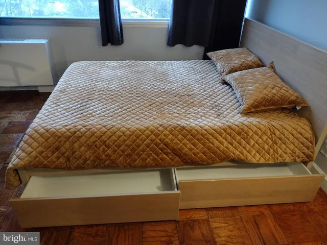 a bedroom with a bed and a window