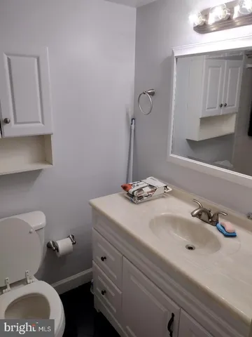a bathroom with a sink a toilet and mirror
