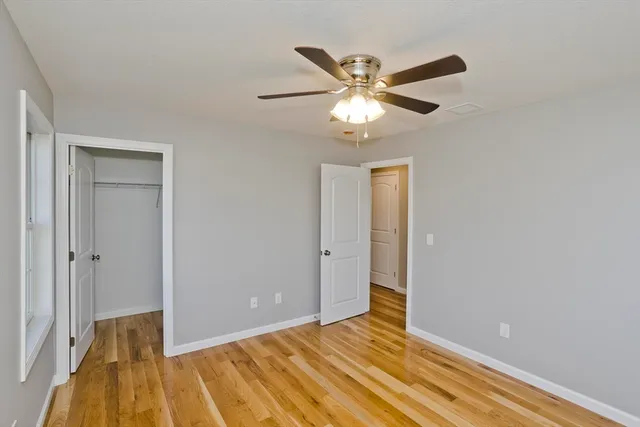 a view of a room with wooden floor and bathroom