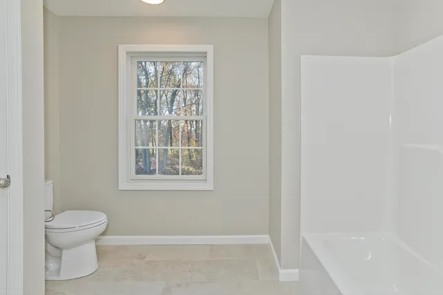 a bathroom with sink toilet and window