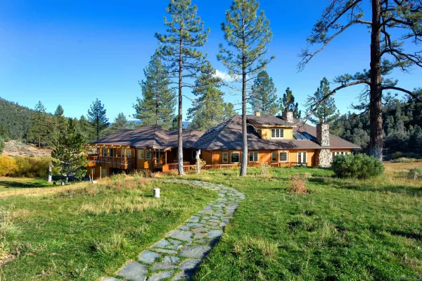 a front view of house with yard and green space