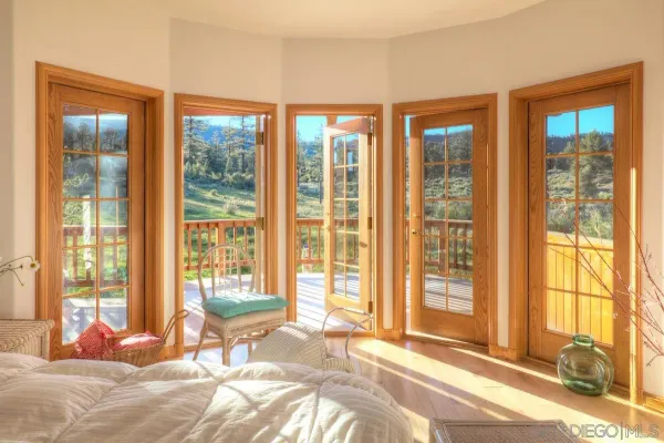 a bedroom with a bed and glass windows