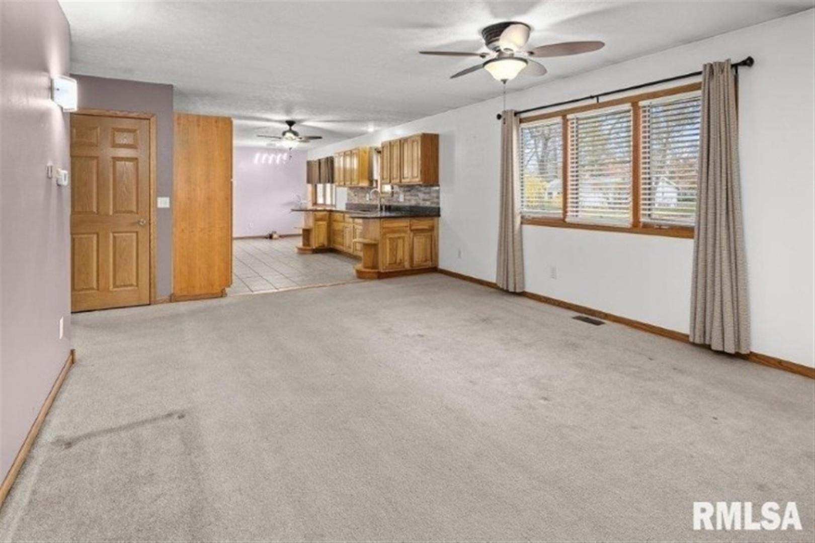 304 7th Street Hampton, IL 61256 - Photo 16 of 35 a view of a livingroom with a chandelier fan and windows