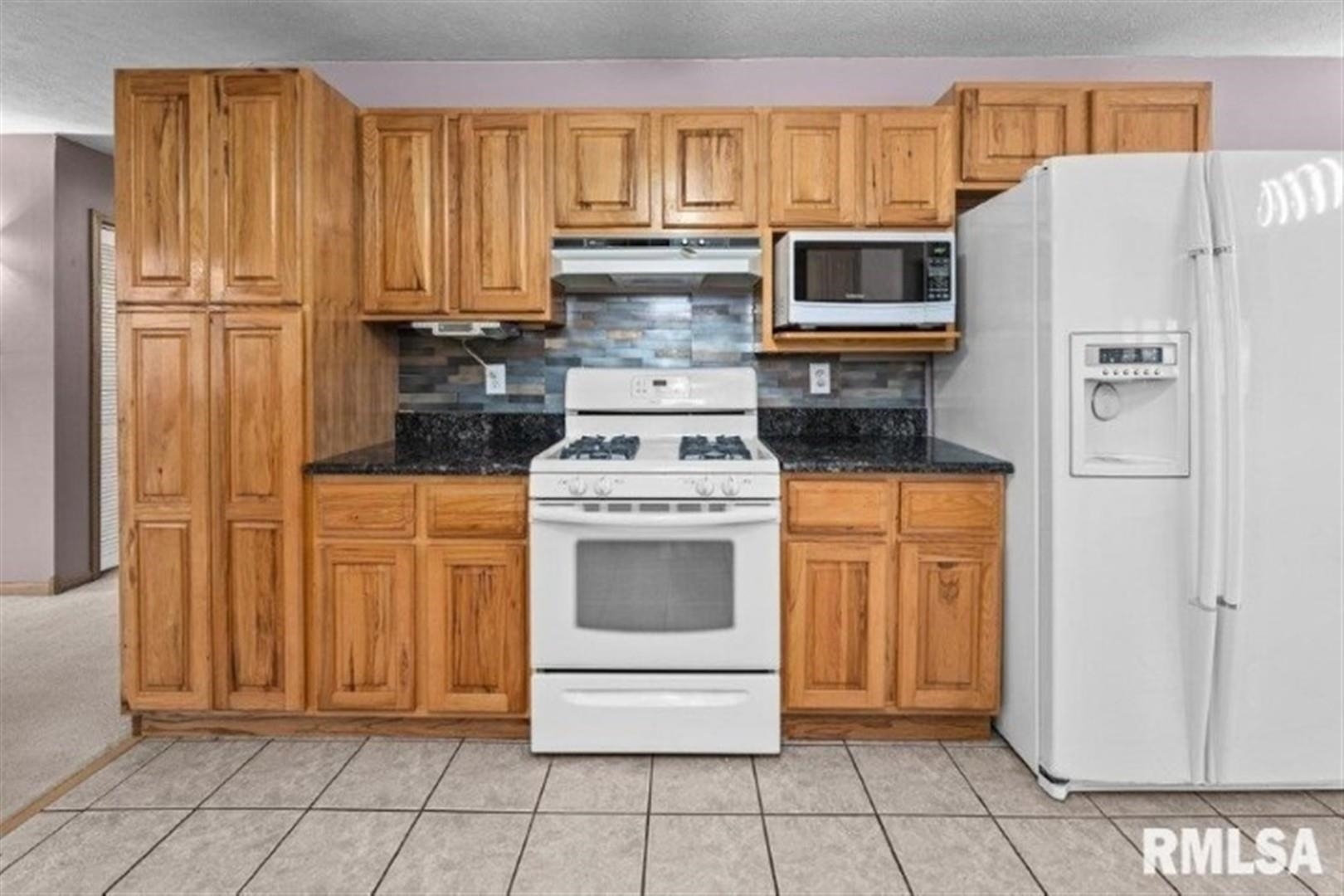 304 7th Street Hampton, IL 61256 - Photo 20 of 35 a kitchen with white cabinets and white appliances