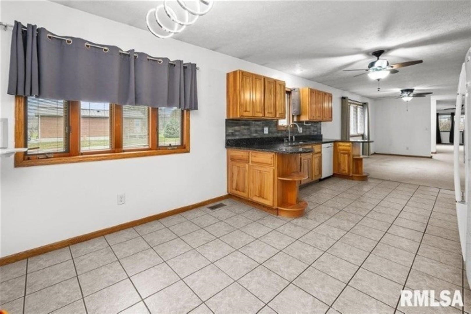 304 7th Street Hampton, IL 61256 - Photo 21 of 35 a kitchen with stainless steel appliances a sink cabinets and window