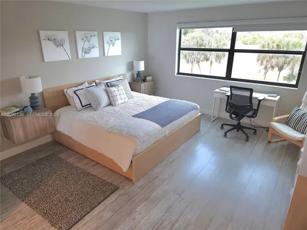 a bedroom with bed and a window