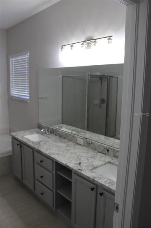 12503 Sparkleberry Road Tampa, FL 33626 - Photo 7 of 8 a bathroom with a granite countertop sink and a mirror