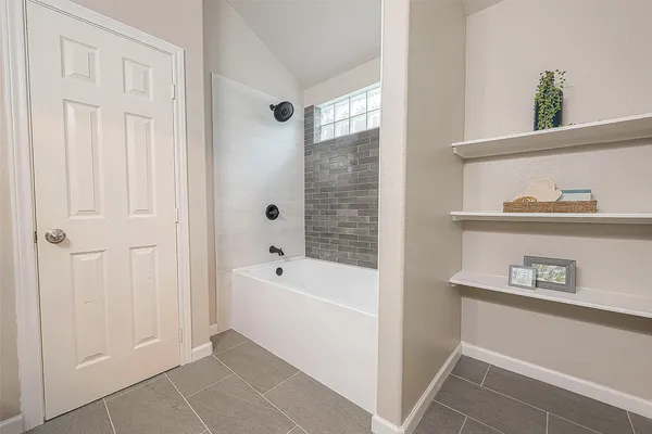 a bathroom with a bathtub and a shower