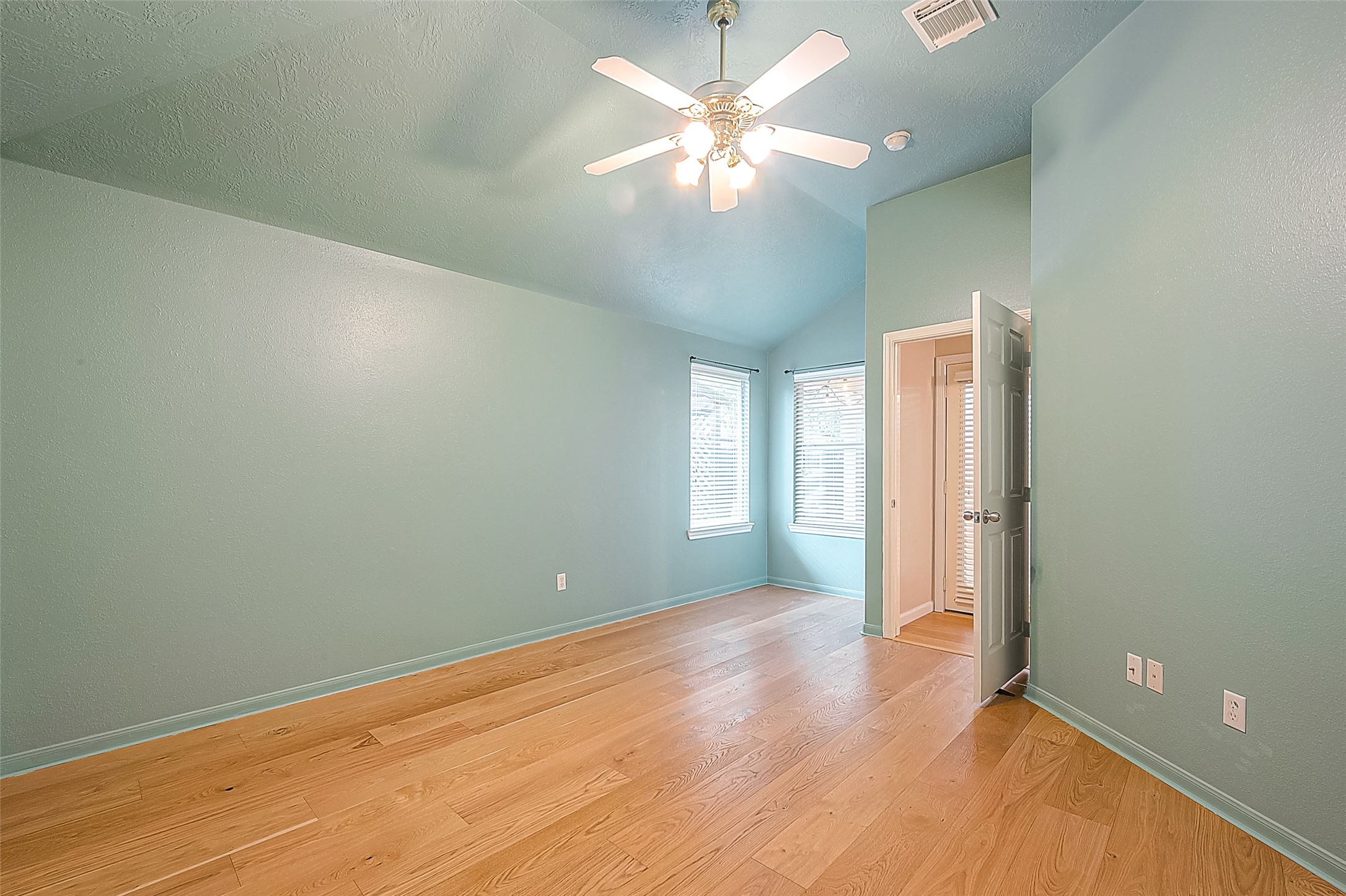 2910 Crescent Bend Road Spring, TX 77388 - Photo 20 of 30 an empty room with wooden floor and a ceiling fan