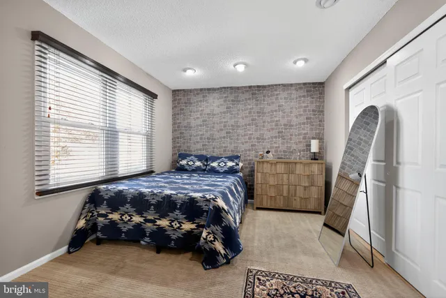 a bedroom with a bed and a dresser