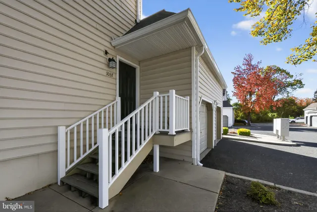 a view of a street with wooden fence