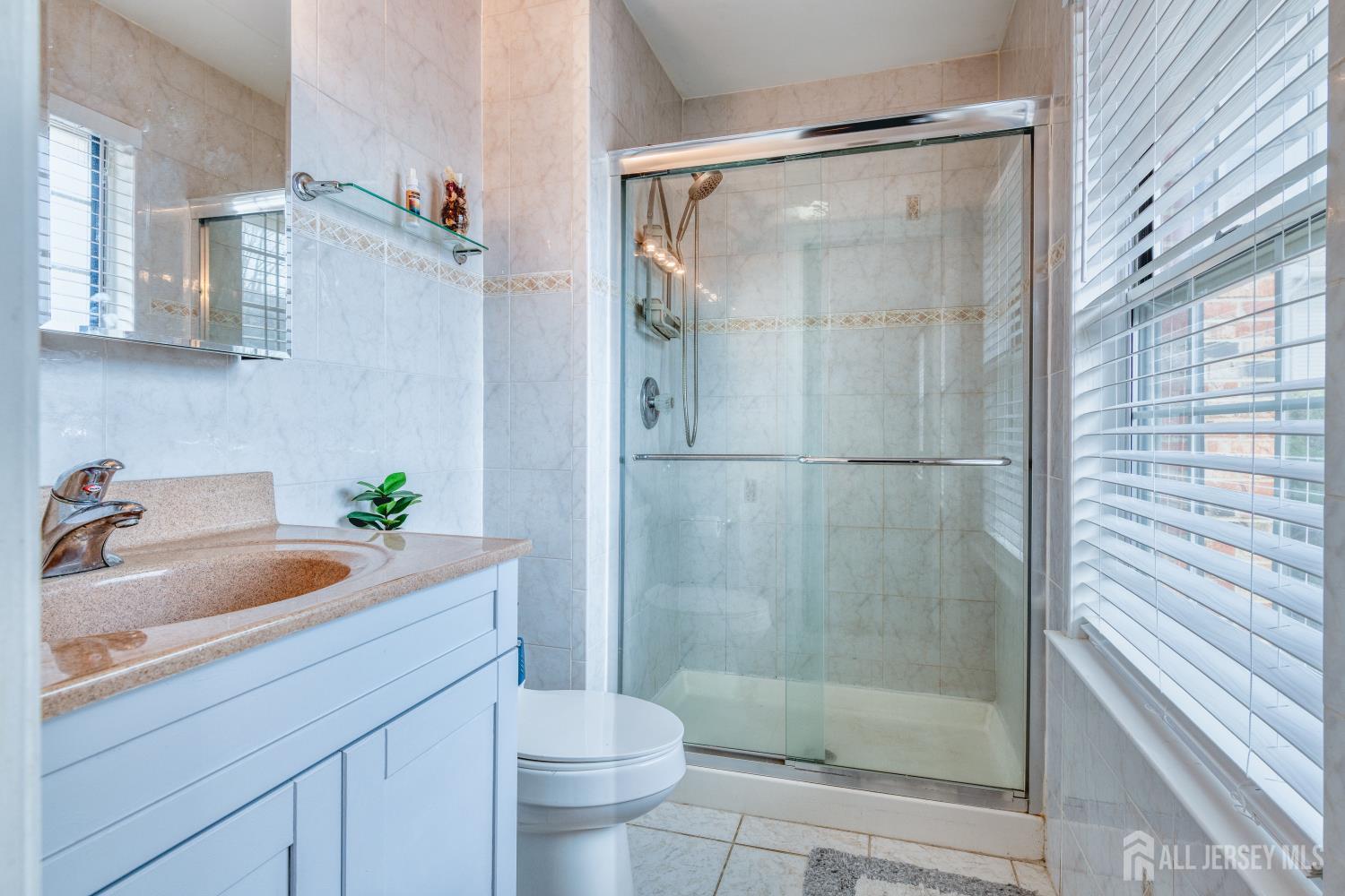 105 Neilly Court Old Bridge, NJ 08857 - Photo 12 of 24 a bathroom with a tub shower sink and mirror