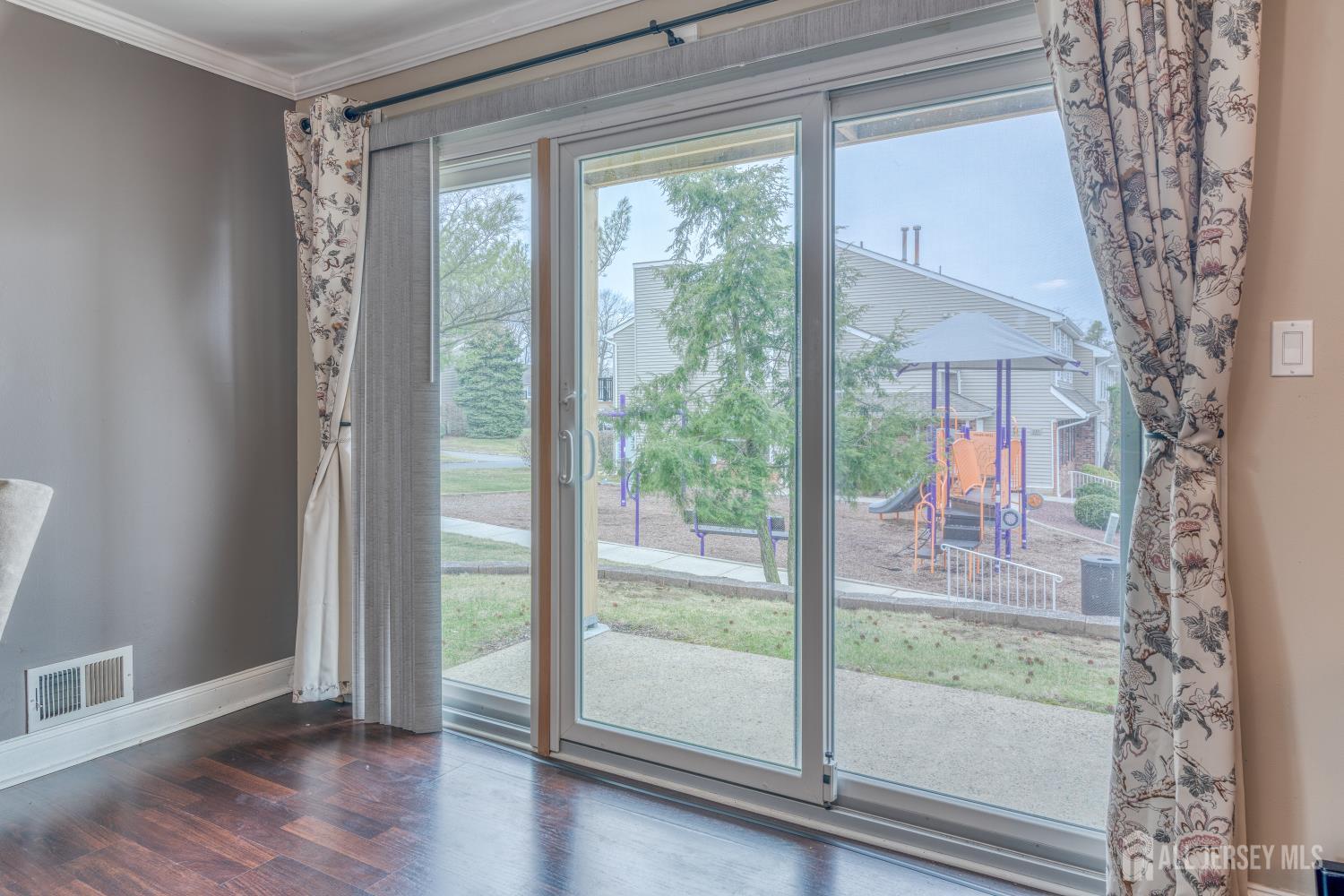 105 Neilly Court Old Bridge, NJ 08857 - Photo 19 of 24 a view of empty room with wooden floor and floor to ceiling window