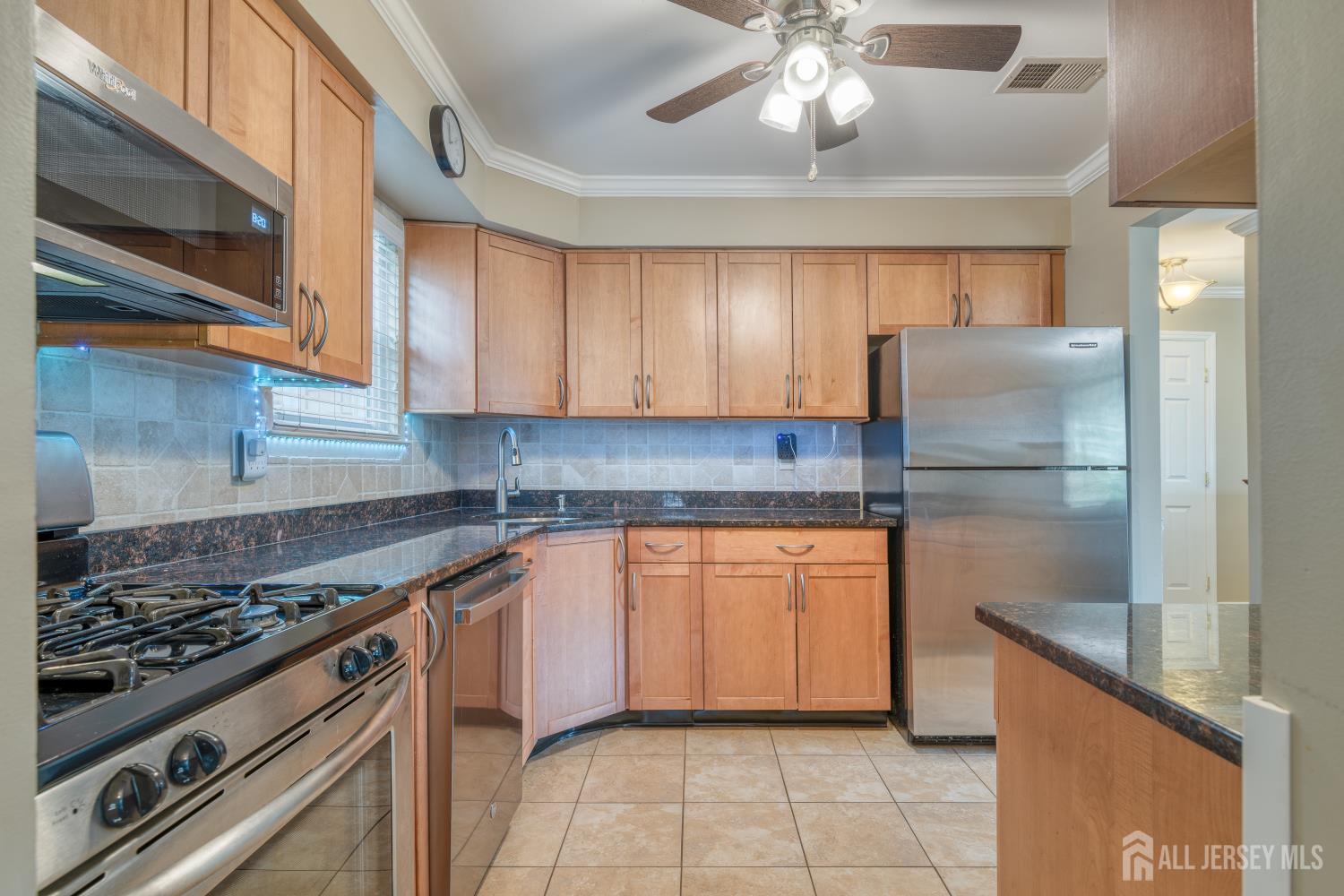 105 Neilly Court Old Bridge, NJ 08857 - Photo 8 of 24 a kitchen with stainless steel appliances granite countertop a sink a stove a refrigerator and cabinets