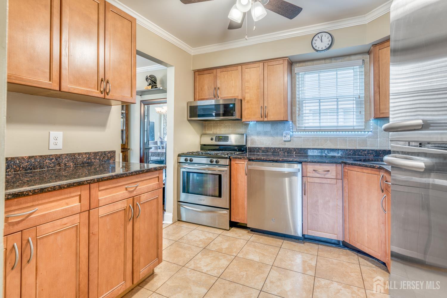 105 Neilly Court Old Bridge, NJ 08857 - Photo 9 of 24 a kitchen with granite countertop cabinets stainless steel appliances a sink and a window