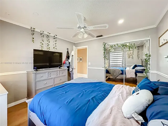 a bedroom with furniture and a flat screen tv