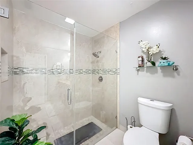 a bathroom with a toilet and shower