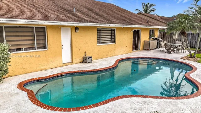 a swimming pool with outdoor seating