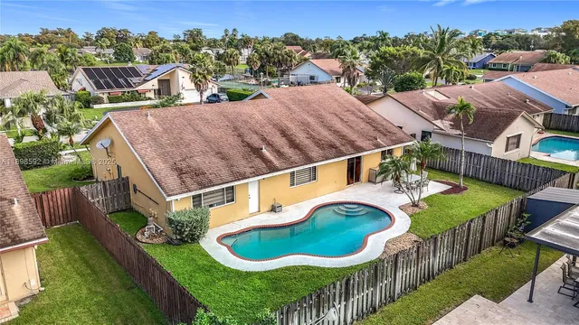 a view of a house with swimming pool and porch