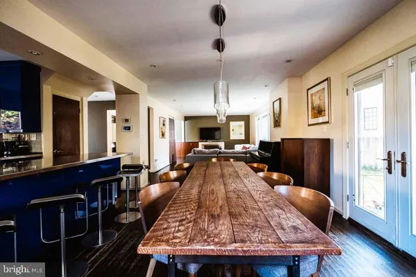 a living room with dining table and wooden floor
