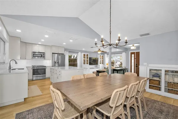 a large kitchen with a table and chairs