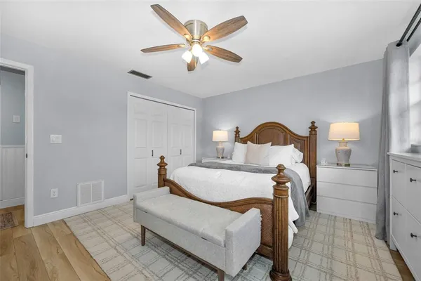 a bedroom with a bed and a chandelier