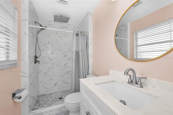 a bathroom with a sink toilet and shower
