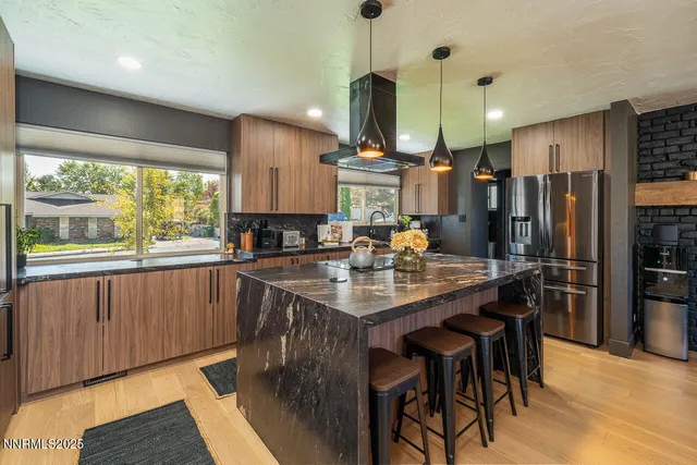 a kitchen with a table chairs stove and cabinets