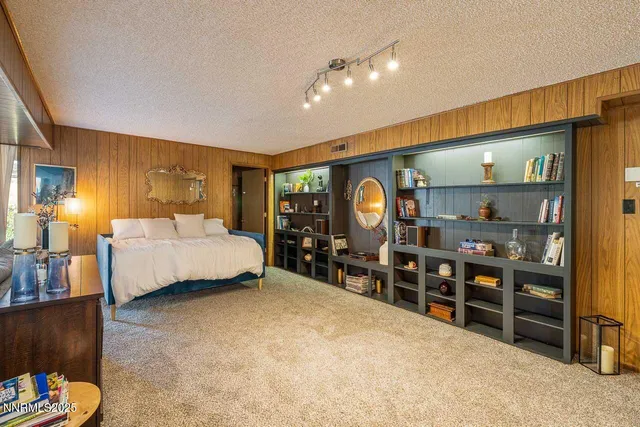 a bedroom with a bed and a desk
