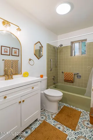 a spacious bedroom with a bed a couch and a chandelier